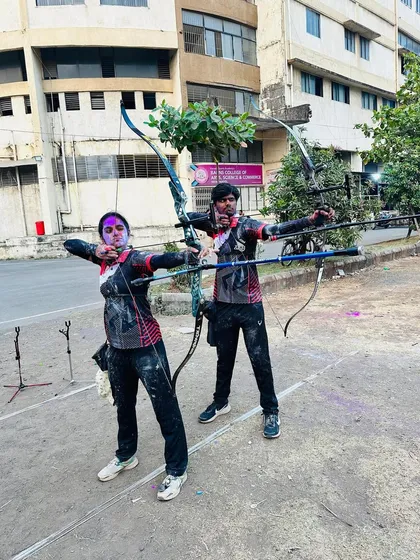 Archery and Holi celebrations. Two of our students take a fun shot together, covered in colors, showcasing the fun and festive side of our academy.