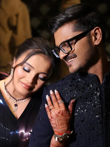 An intimate moment between the bride and groom. Her glamorous eye makeup is visible even in this soft, romantic shot, perfect for a Sangeet night.