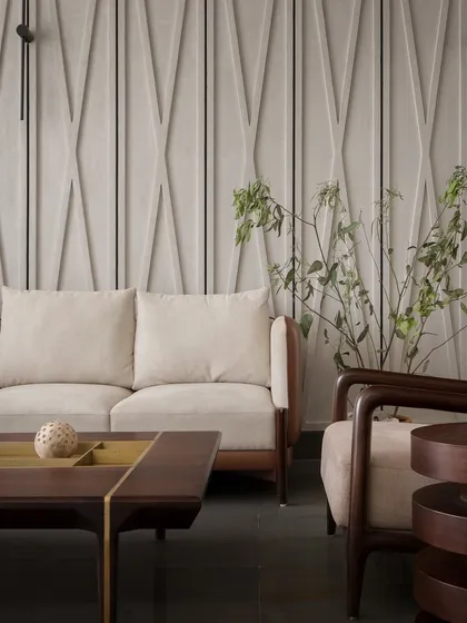 Another view of the living area, showing the sculpted wall paneling and warm, earthy tones. The design balances restraint with character, creating a comfortable and inviting space.