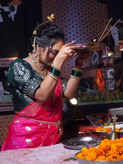 Performing aarti during Ganesh Utsav. The makeup is designed to glow beautifully in the warm light of the diyas.