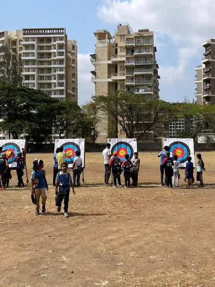 Young archers walking back from the targets during the Drona Cup. These events are a great social experience for the kids.
