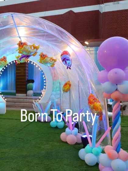 An incredible igloo-like entrance tunnel for an underwater party, decorated with fish balloons to make guests feel like they're entering the ocean.