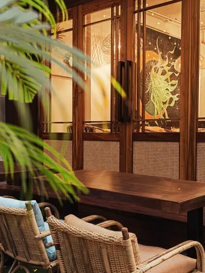 As evening falls, the cafe transforms into a cozy, intimate space. The warm lighting and view into our studio create a perfect backdrop for a quiet dinner.