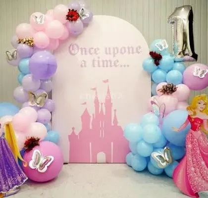 A 'Once upon a time' princess-themed first birthday with Rapunzel and Aurora cutouts.