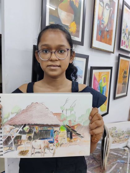 A young student works on a detailed landscape drawing with color pencils, learning to recreate a complex scene from a reference photo.
