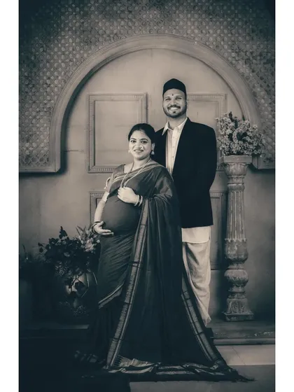 A regal maternity portrait celebrating heritage and the creation of a new family legacy. This studio session uses a vintage Maharashtrian theme, with traditional attire and classic monochrome toning to create a powerful, timeless piece of art.