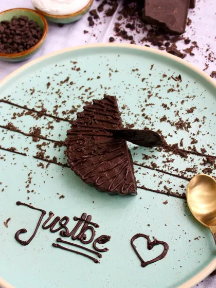 A slice of our rich, dark chocolate cake, plated with a touch of love. It's the perfect way to add a dash of sweetness to your celebration.
