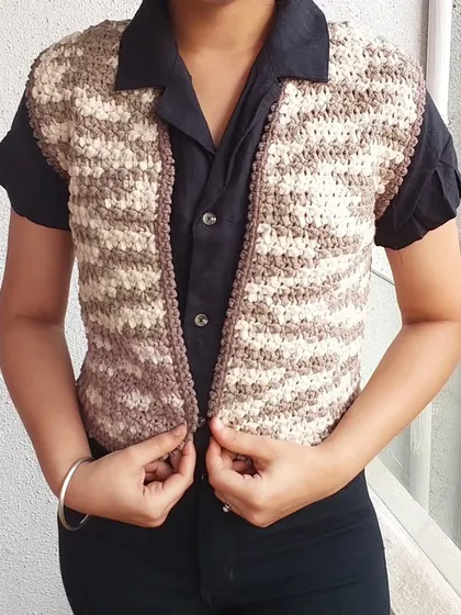 The Lisa Vest is a great layering piece that can be worn over a collared shirt for a preppy look.