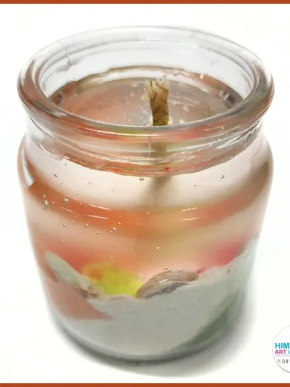 A creative gel candle with colorful layers, made in a simple glass jar. A perfect beginner-friendly craft project.