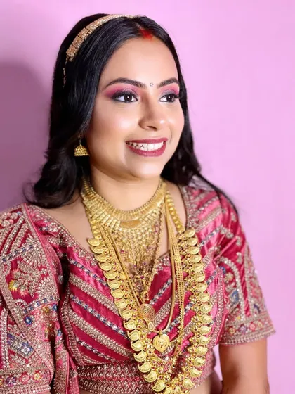 A beautiful smile from my reception bride. The bold makeup is balanced with a flawless base, ensuring she looks stunning throughout her event.