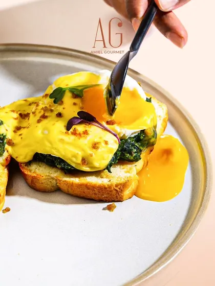 A perfect morning starts with a perfect egg. My Eggs Benedict, served on fresh brioche with a rich, velvety hollandaise, is a true breakfast classic. The runny yolk is my favorite part.