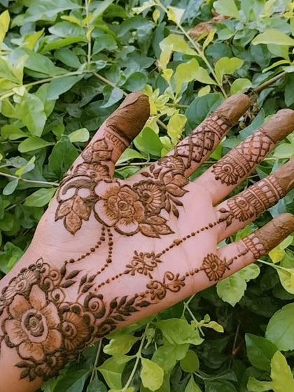 This design features a beautiful floral chain, or 'bel', that gracefully adorns the hand. The greenish-brown color is the natural shade of my fresh henna paste before it dries and stains the skin.