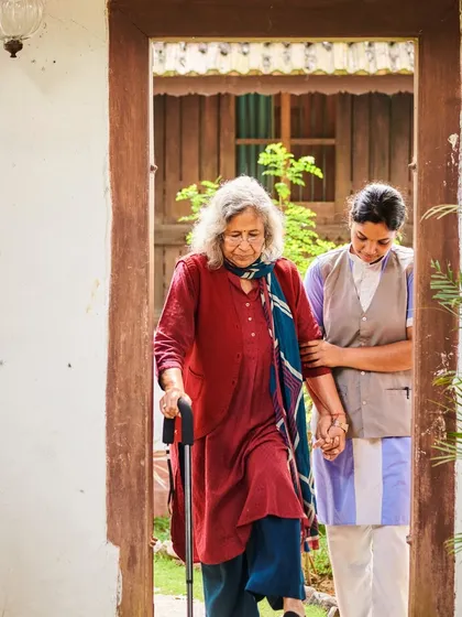 Compassion in action. One of our dedicated therapists provides gentle support to an elderly guest, ensuring she moves safely and comfortably. Our team is committed to providing heartfelt care to every person who walks through our doors.