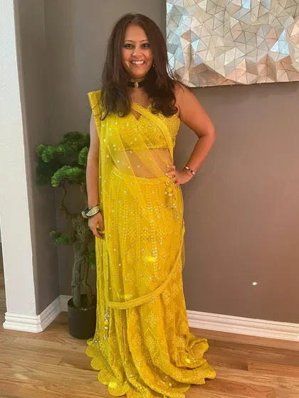 This client looks absolutely radiant in a bright yellow sequined lehenga saree. She has kept her jewellery minimal with a simple choker, letting her vibrant outfit be the star.