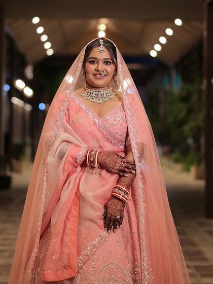 A beautiful portrait of our bride in pink. The makeup is soft and romantic, with a focus on a flushed, youthful glow that perfectly matches her outfit.
