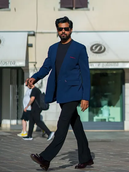 The lapel-free blazer in motion, showcasing its clean lines and effortless style.
