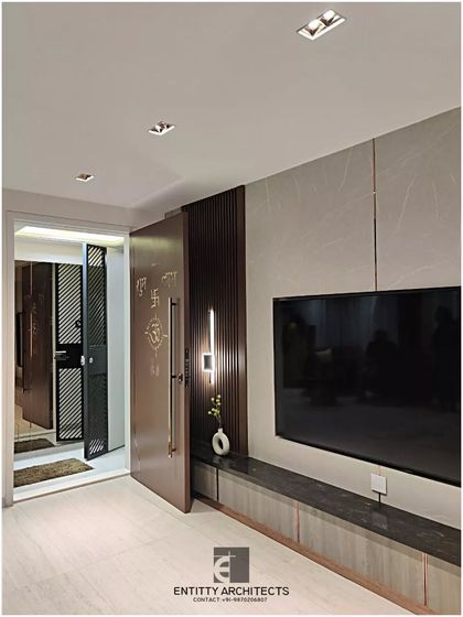 This view shows the main entrance and TV unit from our Pote Residence project. The design emphasizes clean lines, with a floating console and subtle rose gold inlays that add a touch of understated luxury.
