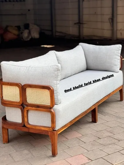Side view of the light grey sofa, showing the unique arm design.