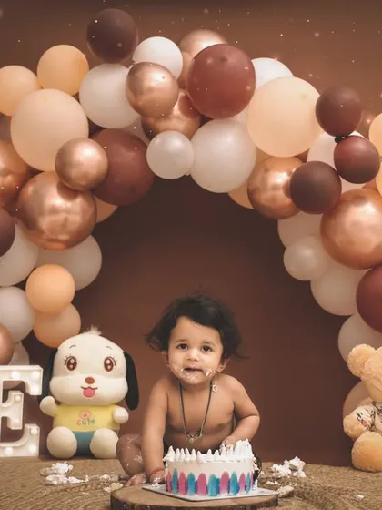 Turning one is a huge milestone, and we celebrate it with a bang. This cake smash session is set against a beautiful balloon arch, capturing the pure joy and curiosity of your little one's first taste of birthday cake.