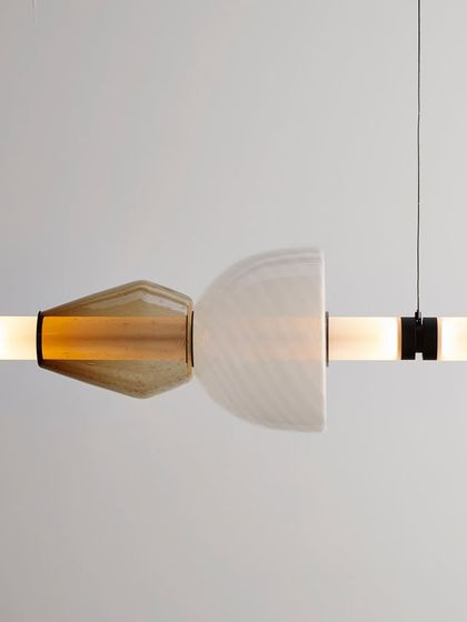 A detailed view of another Luna Kaleido combination, this time with a swirled white glass dome and a smoky, cone-shaped element.