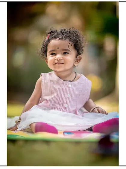 A sweet and gentle smile from this little girl during her outdoor portrait session. The soft lighting is perfect for capturing her delicate features.