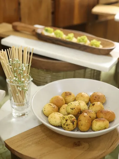 A platter of herbed potato bites, perfect for passing around at a networking event. These savoury morsels are simple, comforting, and universally loved.