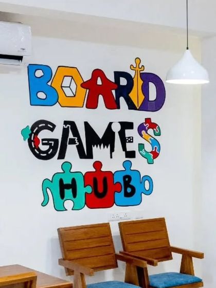 The custom-designed "Board Games Hub" logo mural, featuring letters made of different game elements.