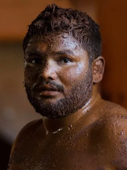 The face of determination. A close-up of Kumar Maharashtra Kesari, Pailwan Vaibhav Raskar, after a grueling session in the 'lal mati', showing the focus and grit required at the highest level.