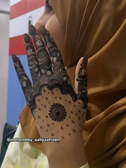 A unique back-hand design for Eid, using black henna for a bold look.