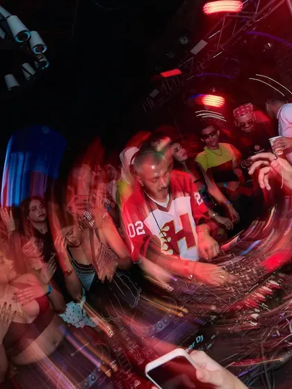 A blurry, high-energy photo that captures the motion and chaos of the dance floor.