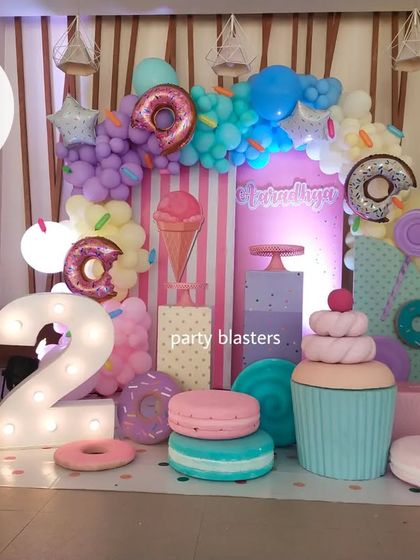 Another view of the Candyland party, highlighting the pastel color scheme and the variety of oversized sweet treat props.