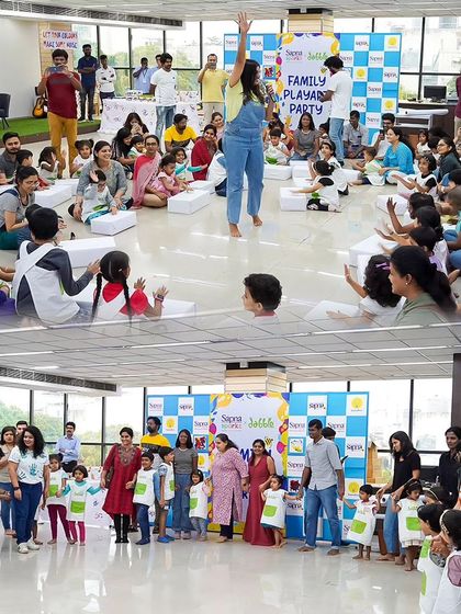 Our event space filled with families engaged in creative activities. This photo shows the community feel of our workshops, where everyone comes together to play and learn.