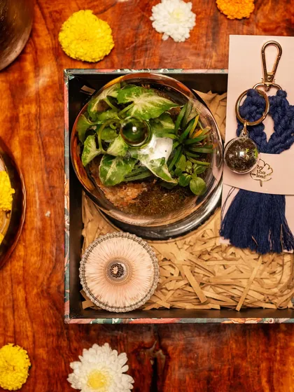 An overhead view of one of my curated gift boxes, showing how the cloche terrarium, macrame keychain, and candle are nestled together. It’s a complete, ready-to-give present for any special occasion.