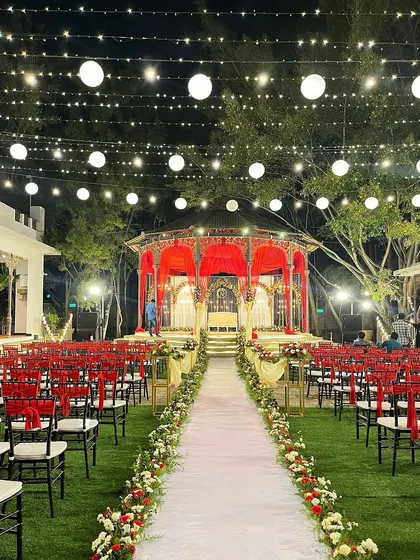 The view down the aisle towards the romantic red reception stage, ready for the couple's grand entrance.