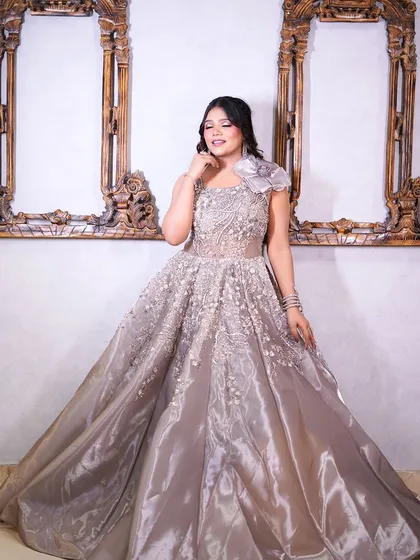 This grey gown with a floral shoulder detail is the definition of sophisticated elegance.