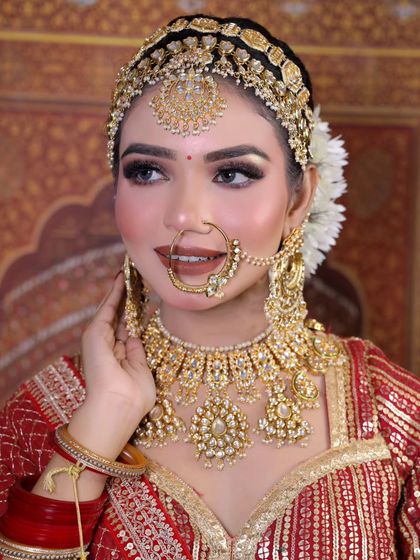 A happy bride in her full golden Polki set, showing how the jewellery shines and completes the bridal look.