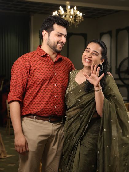 A playful and happy shot from our anniversary series. My laughing expression and wave to the camera make this an engaging and joyful image.