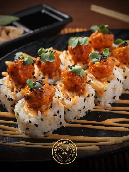 Crispy popcorn shrimp sushi rolls drizzled with a spicy mayo sauce and sprinkled with black sesame seeds. A modern and delicious twist on a classic favorite.
