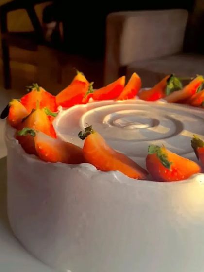 A close-up of the fresh strawberries on my classic strawberry cake, captured in the beautiful golden hour light.