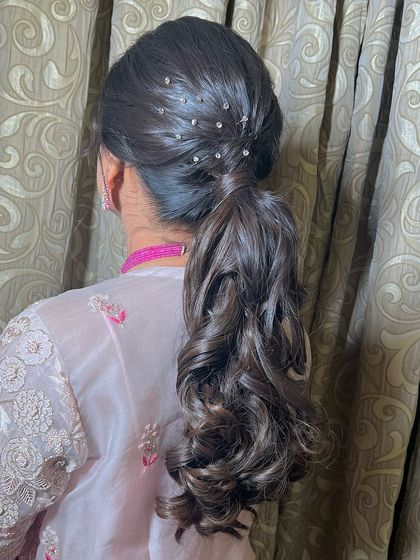 Another angle of the curly, sparkling ponytail, a great choice for a Sangeet or reception.