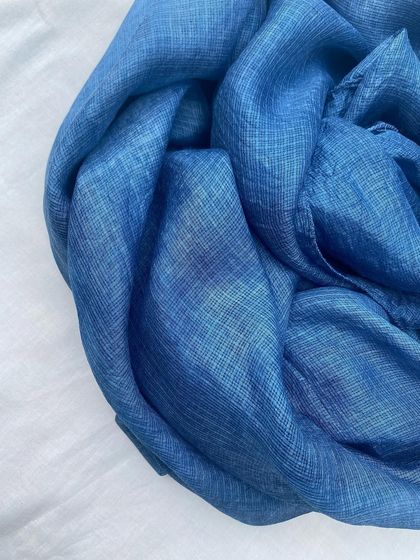 A close-up of the Kota silk stole, showing the rich texture and deep blue of the natural indigo dye.