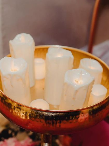 Another detail shot of the candle decor. The warm glow of the candles, set in a hammered brass bowl, adds a touch of elegance and romance to the reception setup.