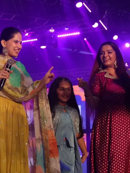 Another angle of my interaction with Jaya Kishori, showing the scale of the stage and the audience's engagement.