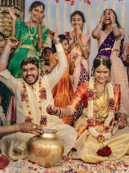 A moment of pure fun and games during a South Indian wedding ceremony, with the couple and their family sharing a huge laugh.