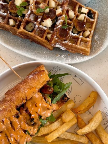 A brunch spread of waffles and a sandwich at Neighbors Goa. I like to show a variety of dishes to give a sense of the menu's range, from sweet to savory.