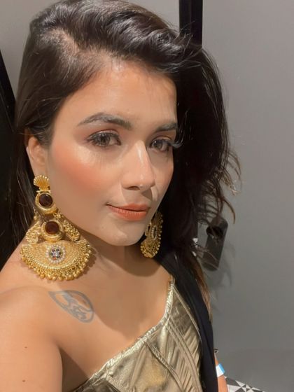 A client looking absolutely radiant in my oversized gold-tone chaandbali earrings. These statement pieces are designed to be bold and beautiful, perfect for making an impression at any celebration.