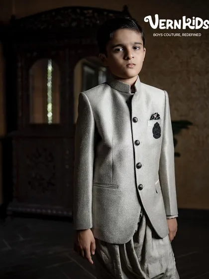 This outfit is designed for boys who are ready to turn heads. A sophisticated grey Jodhpuri jacket paired with a stylish dhoti-style pant creates a modern yet traditional look for any grand occasion.