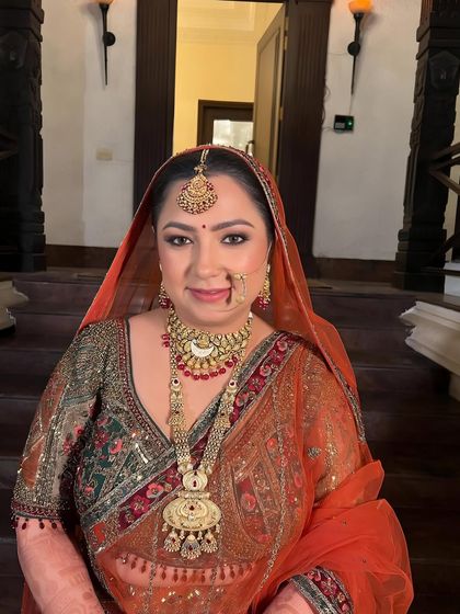 A happy bride, her face lit up with a radiant glow. The makeup is designed to look fresh and beautiful all day.