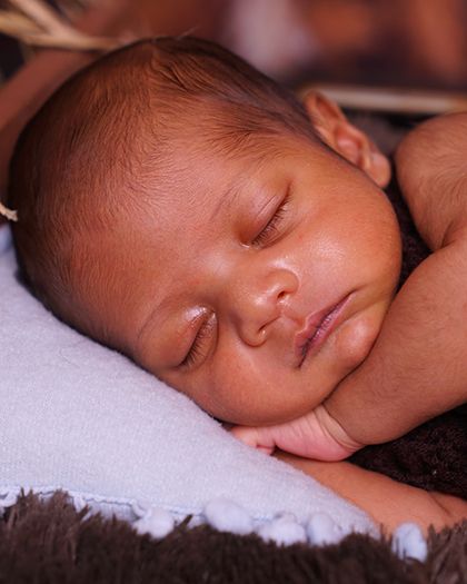 A close-up on the newborn's peaceful face. I use lighting that enhances their soft skin and delicate features.