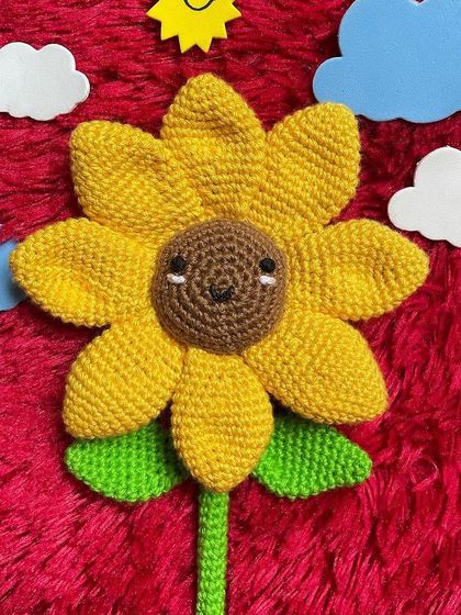 A single smiley sunflower stem against a fun, colorful background. This little guy is guaranteed to make you smile.